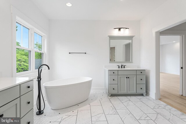 4763 Williamsburg Blvd, Arlington, VA 22207 - bathroom with vanity, marble finish flooring, a freestanding tub, recessed lighting, and baseboards