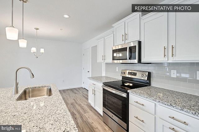 325 Magnolia Ln Lot 103, State College, PA 16803 - kitchen featuring white cabinets, a sink, light wood-style flooring, backsplash, and stainless steel appliances