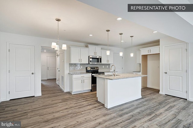 325 Magnolia Ln Lot 103, State College, PA 16803 - kitchen with light wood-style floors, appliances with stainless steel finishes, white cabinets, and backsplash
