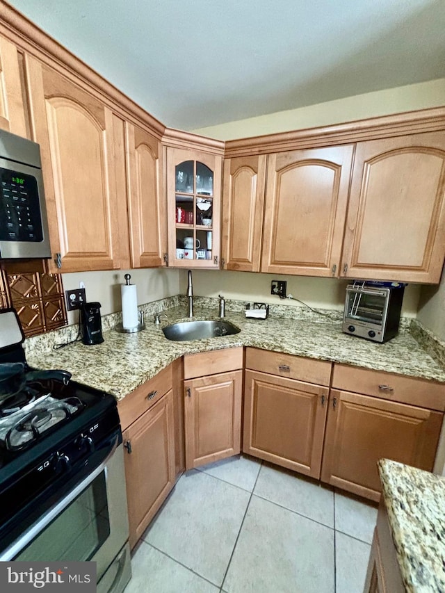 113 Lexington Dr, Tuckerton, NJ 08087 - kitchen with stainless steel appliances, a sink, light tile patterned floors, glass insert cabinets, and light stone counters