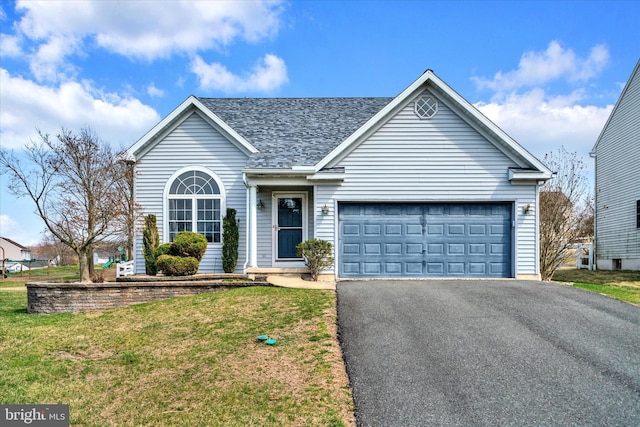 single story home with an attached garage, roof with shingles, driveway, and a front lawn