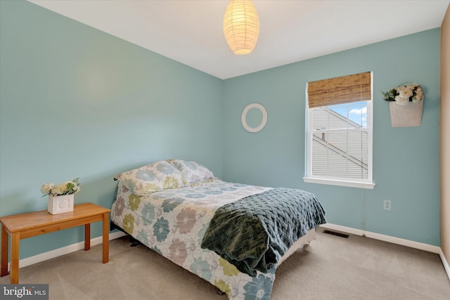 bedroom featuring visible vents, baseboards, and carpet floors
