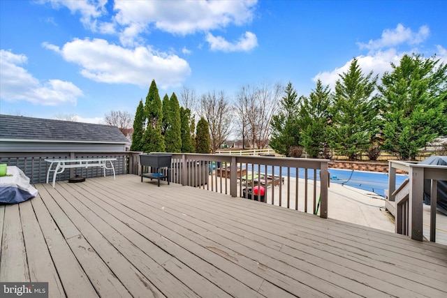 wooden deck with a covered pool