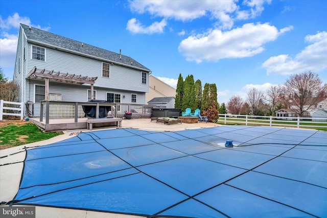 view of pool featuring a hot tub, fence, a patio, a pergola, and a fenced in pool