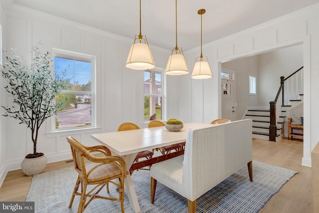 40928 Arcadian Pond Ct, Aldie, VA 20105 - dining area with a decorative wall, light wood-type flooring, and stairs