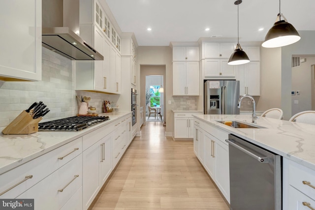 40928 Arcadian Pond Ct, Aldie, VA 20105 - kitchen with stainless steel appliances, wall chimney range hood, a sink, light wood-type flooring, and white cabinets