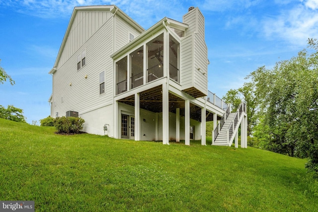 40928 Arcadian Pond Ct, Aldie, VA 20105 - rear view of property featuring a sunroom, a lawn, a chimney, and stairway