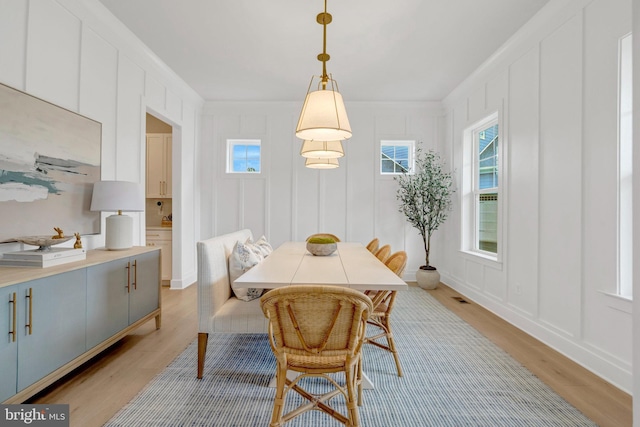 40928 Arcadian Pond Ct, Aldie, VA 20105 - dining room featuring a decorative wall, light wood-style floors, healthy amount of natural light, and ornamental molding