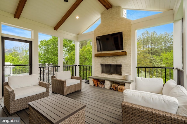 40928 Arcadian Pond Ct, Aldie, VA 20105 - sunroom / solarium featuring an outdoor living space with a fireplace, beam ceiling, wood finished floors, plenty of natural light, and high vaulted ceiling