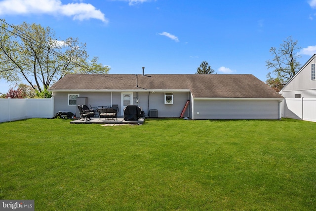 back of house featuring a lawn, a patio, cooling unit, and a fenced backyard