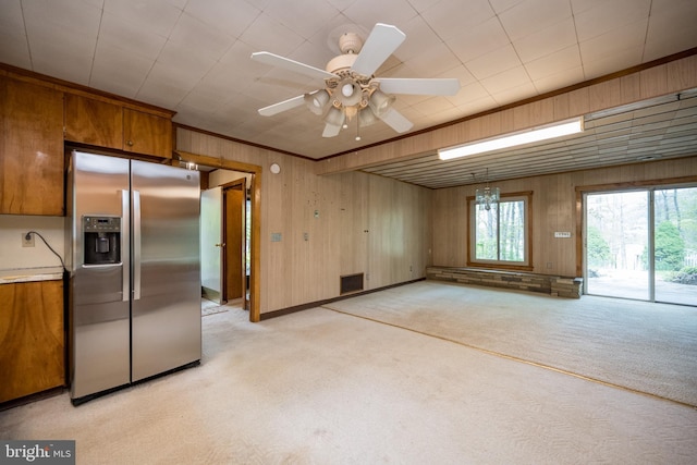 1321 Marsh Hill Rd, Mc Henry, MD 21541 - kitchen featuring stainless steel fridge, light carpet, brown cabinetry, wood walls, and crown molding