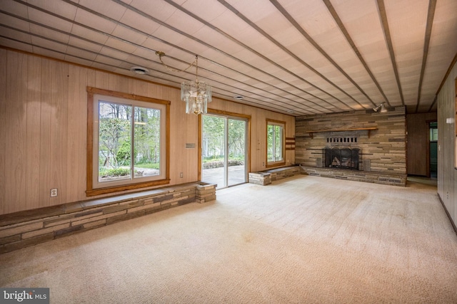 1321 Marsh Hill Rd, Mc Henry, MD 21541 - unfurnished living room featuring wooden walls, carpet floors, a stone fireplace, and a chandelier