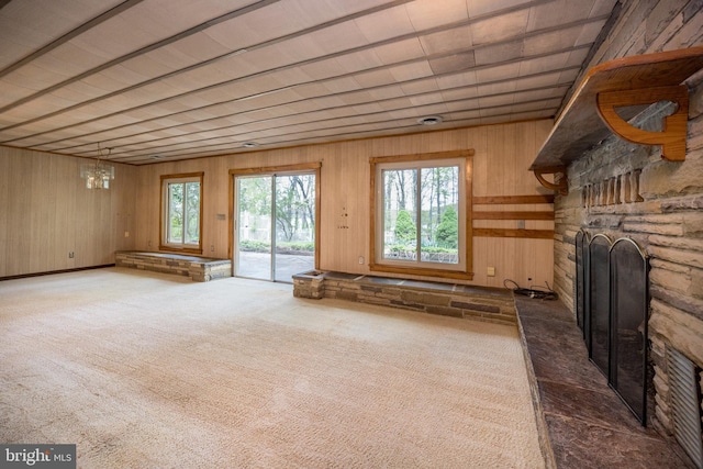 1321 Marsh Hill Rd, Mc Henry, MD 21541 - unfurnished living room with a fireplace, wood walls, and carpet floors