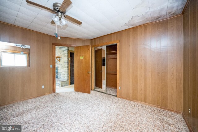 1321 Marsh Hill Rd, Mc Henry, MD 21541 - unfurnished bedroom with carpet flooring, wood walls, a ceiling fan, and a closet