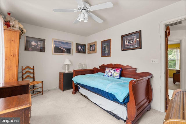 carpeted bedroom with baseboards, a ceiling fan, and visible vents