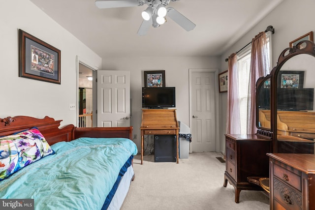 bedroom with ceiling fan and light colored carpet