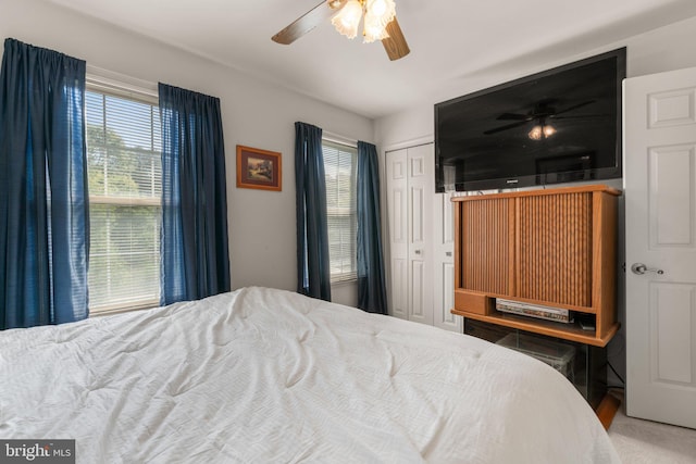 bedroom with a ceiling fan and a closet