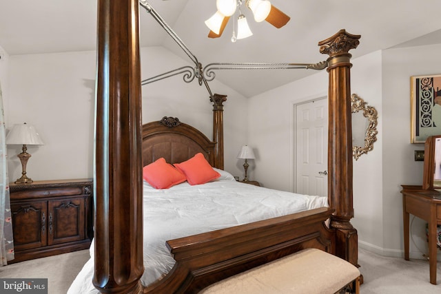 bedroom featuring baseboards, ceiling fan, light carpet, and vaulted ceiling