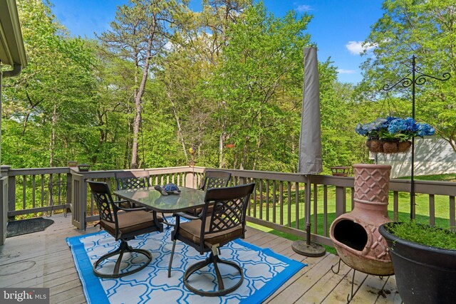 wooden deck featuring outdoor dining area