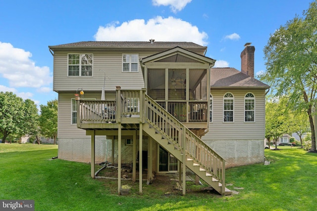 rear view of property featuring a yard, stairs, a chimney, and a sunroom
