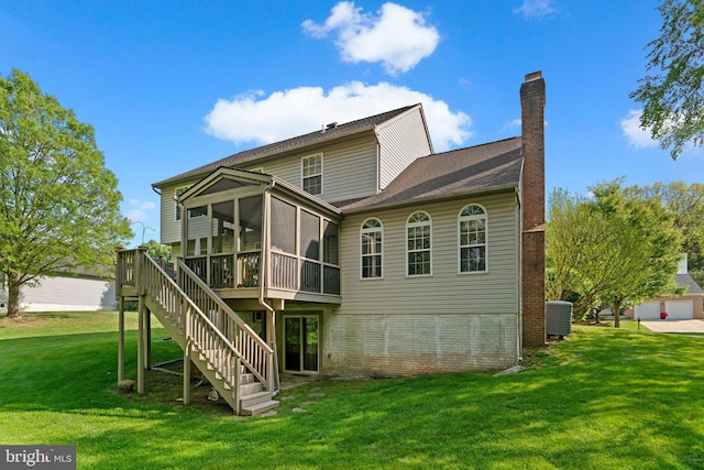back of property featuring cooling unit, a chimney, a sunroom, stairs, and a lawn