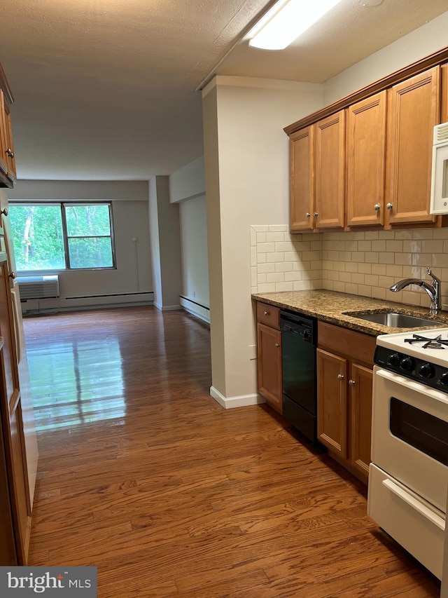 kitchen featuring white appliances, a baseboard heating unit, a sink, and wood finished floors