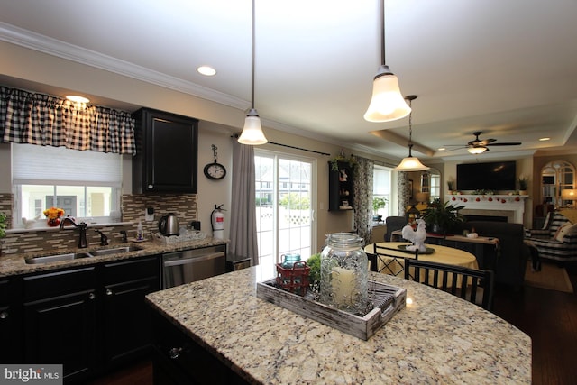 kitchen featuring crown molding, a sink, dark cabinetry, and dishwasher