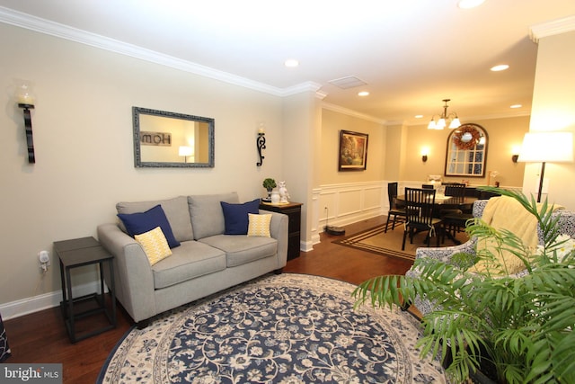 living area featuring recessed lighting, an inviting chandelier, ornamental molding, and wood finished floors