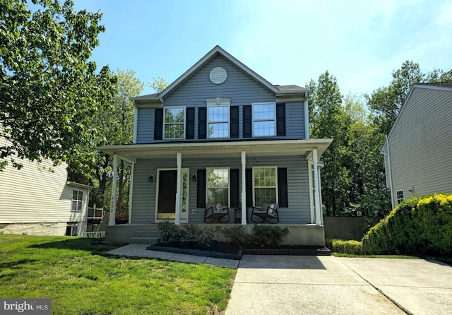 view of front facade with covered porch and a front yard