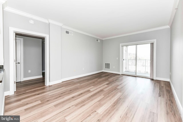 unfurnished room with visible vents, ornamental molding, and light wood-style floors