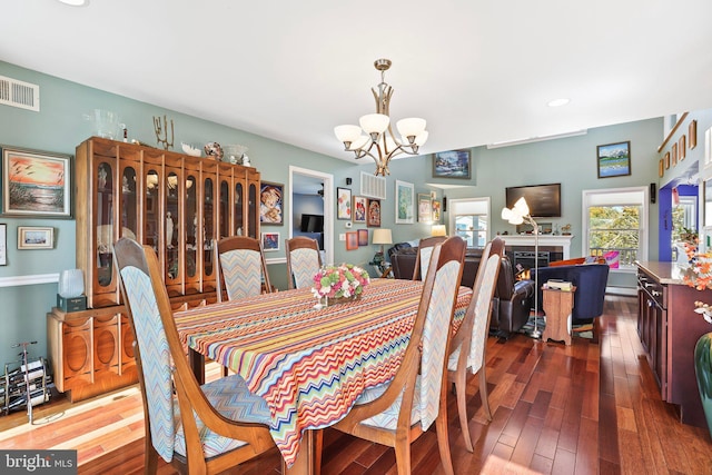 1511 Barnegat Ave, Ship Bottom, NJ 08008 - dining room featuring visible vents, a warm lit fireplace, a notable chandelier, recessed lighting, and dark wood-type flooring