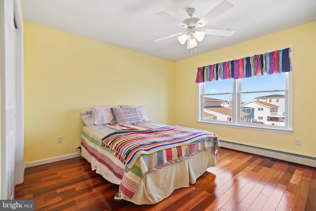 1511 Barnegat Ave, Ship Bottom, NJ 08008 - bedroom with baseboard heating, baseboards, ceiling fan, and wood finished floors