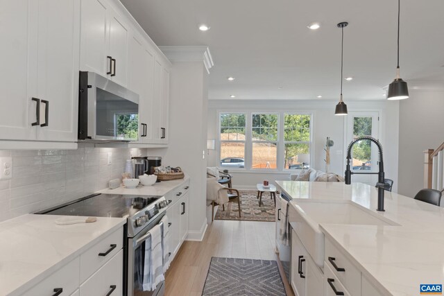 kitchen with stainless steel appliances, recessed lighting, a wealth of natural light, and a sink