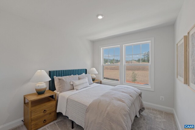 bedroom featuring carpet flooring and baseboards