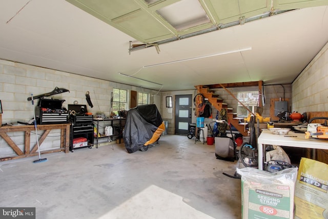 garage featuring concrete block wall and a workshop area