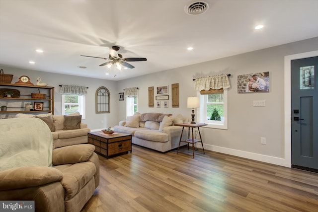living area with visible vents, recessed lighting, wood finished floors, and a wealth of natural light