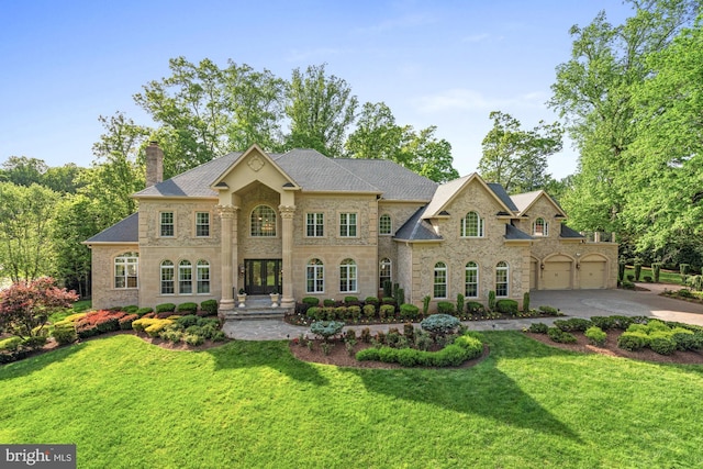 696 Miller Ave, Great Falls, VA 22066 - view of front of home with stone siding, french doors, a chimney, a front lawn, and driveway