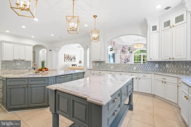 696 Miller Ave, Great Falls, VA 22066 - kitchen featuring an island with sink, gray cabinetry, and white cabinets