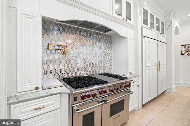 696 Miller Ave, Great Falls, VA 22066 - kitchen with glass insert cabinets, double oven range, white cabinetry, arched walkways, and tasteful backsplash