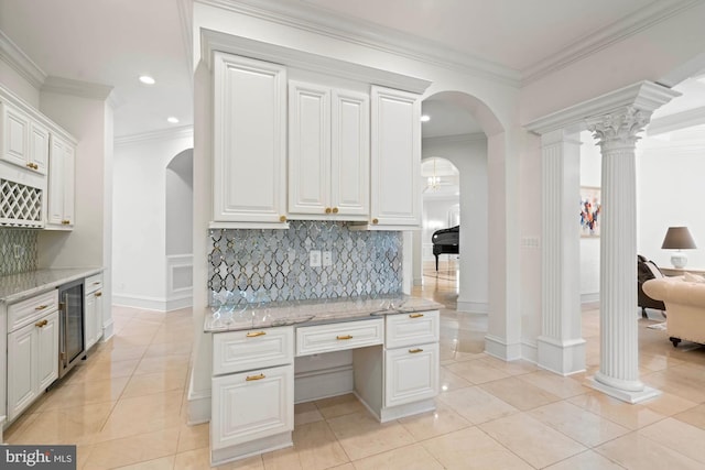 696 Miller Ave, Great Falls, VA 22066 - kitchen with ornamental molding, decorative backsplash, arched walkways, and wine cooler