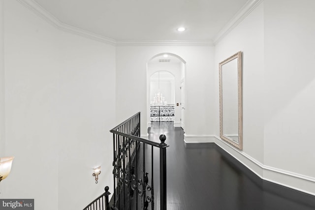 696 Miller Ave, Great Falls, VA 22066 - hall featuring recessed lighting, dark wood-style flooring, crown molding, arched walkways, and an upstairs landing