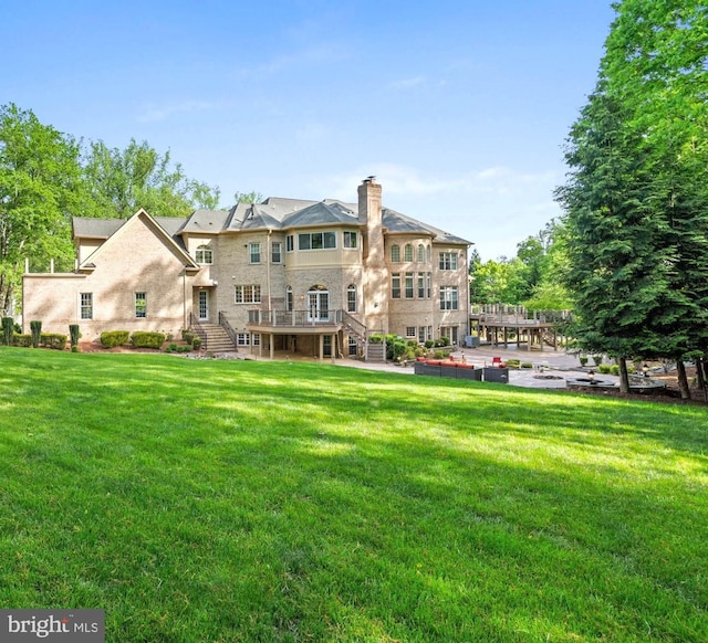 696 Miller Ave, Great Falls, VA 22066 - back of property with a yard, stairs, a chimney, and a deck
