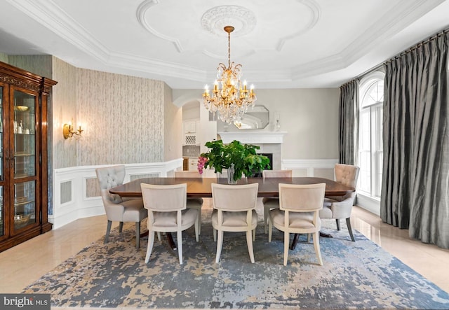 696 Miller Ave, Great Falls, VA 22066 - dining space featuring crown molding, a decorative wall, wainscoting, and a notable chandelier