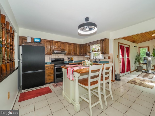 1235 Lorene Dr, Pasadena, MD 21122 - kitchen featuring freestanding refrigerator, double oven range, under cabinet range hood, and tasteful backsplash