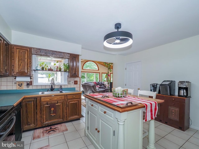 1235 Lorene Dr, Pasadena, MD 21122 - kitchen featuring a sink, light tile patterned floors, and backsplash
