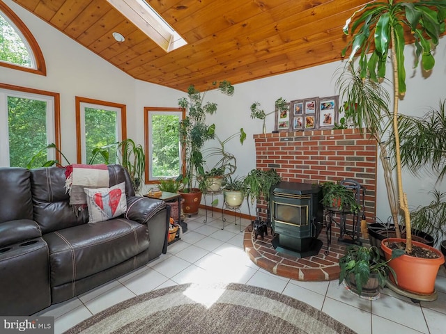 1235 Lorene Dr, Pasadena, MD 21122 - tiled living room with a wood stove, a skylight, baseboards, wood ceiling, and high vaulted ceiling