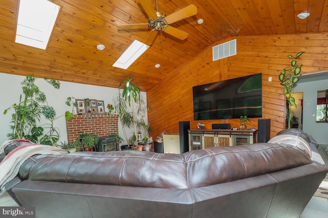 1235 Lorene Dr, Pasadena, MD 21122 - living area featuring a skylight, wooden ceiling, wood walls, a ceiling fan, and tile patterned floors