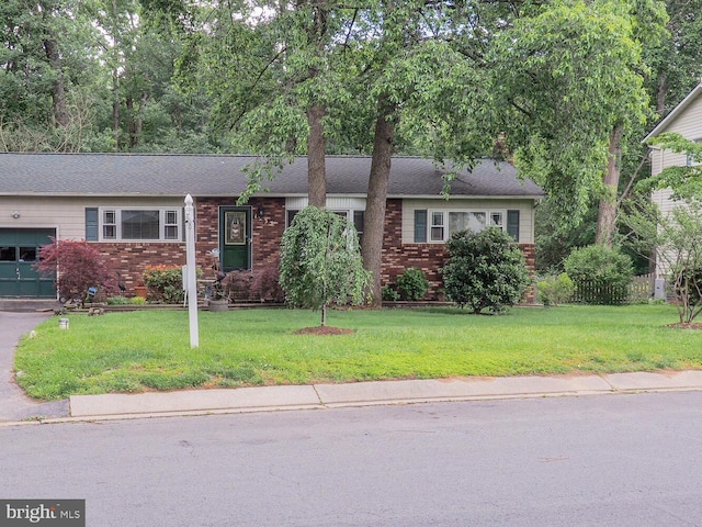 1235 Lorene Dr, Pasadena, MD 21122 - view of front of house featuring a garage, brick siding, a front lawn, and a shingled roof