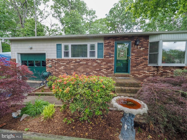 1235 Lorene Dr, Pasadena, MD 21122 - view of front of house with an attached garage and brick siding