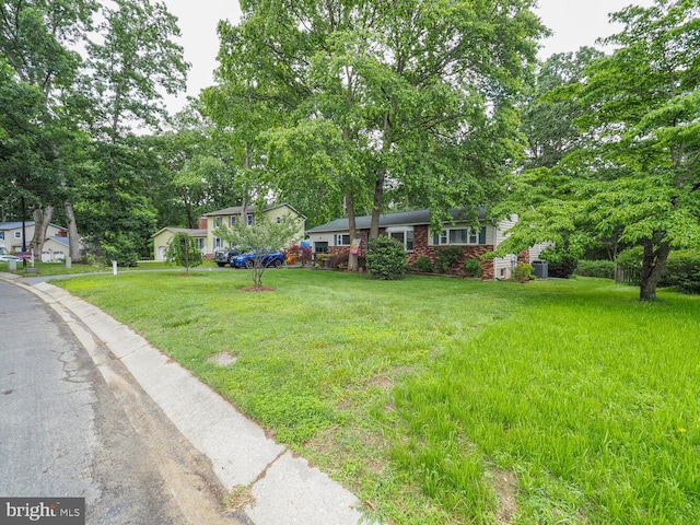 1235 Lorene Dr, Pasadena, MD 21122 - view of front facade with a front yard and brick siding